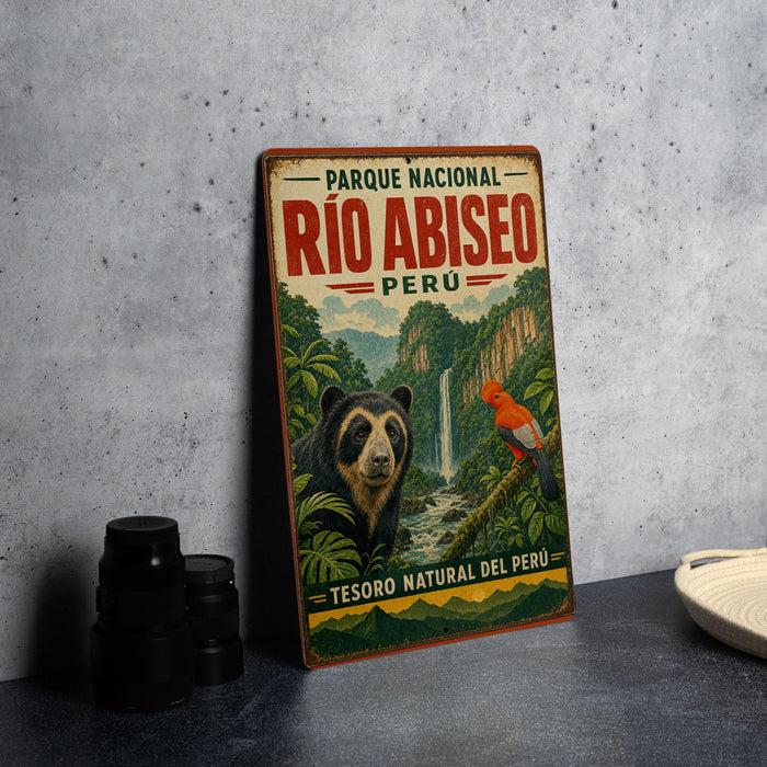 A vintage-style metal sign for the Parque Nacional Rio Abisito in Peru, featuring a bear and a bird in a lush, forested landscape.