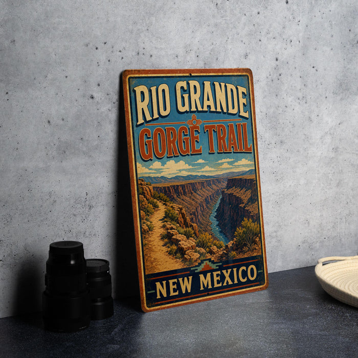 A vintage-style sign for the Rio Grande Gorge Trail in New Mexico, featuring a scenic illustration of the Grand Canyon.
