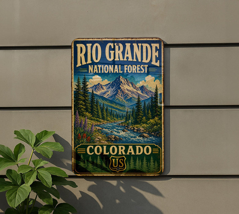 A vintage-style metal sign for the Rio Grande National Forest in Colorado, featuring a scenic mountain landscape with pine trees, a river, and a waterfall.