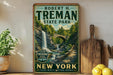A vintage-style poster of Robert H. Treman State Park in New York, featuring a scenic waterfall and bridge, is displayed on a wall next to a wooden cutting board and a potted plant.