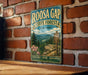A vintage-style metal sign for Roosa Gap State Forest in New York, featuring a scenic mountain landscape and a trail sign.