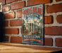 A vintage-style metal sign for Rosalie Mansion, a historic home in Mississippi, is displayed on a brick wall.