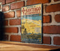 A vintage metal sign displaying the routes of Santiago de Compostela, featuring a map and illustrations of landmarks and cities along the way.