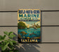 a vintage metal sign with a colorful illustration of marine life, including a bird, fish, and coral, set against a backdrop of a tropical island.