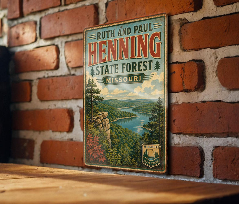 A vintage-style metal sign for the Ruth and Paul Henning State Forest in Missouri, featuring a scenic landscape with a river and mountains.