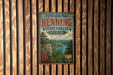 A vintage-style metal sign for the Ruth and Paul Henning State Forest in Missouri, featuring a scenic landscape with a river, mountains, and pine trees.