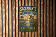 A vintage metal sign for the Sacramento National Wildlife Refuge in California, featuring an illustration of ducks and a birdhouse.