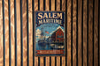 A vintage metal sign for Salem Maritime National Historic Site in Massachusetts, featuring an illustration of a ship and a building.