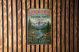 A vintage-style metal sign for the Salmon-Chalis National Forest in Idaho, featuring a scenic mountain landscape with a river and pine trees.