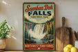 A vintage-style sign for Samboa Deh Falls, a famous waterfall located in Northwest Territories, Canada.