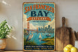 A vintage-style metal sign for San Francisco Bay, featuring a cityscape with the Golden Gate Bridge and sailboats, along with the text "SAN FRANCISCO BAY ESTUARY UNITED STATES" and "WHERE FRESH WATER MEETS THE SEA WILDLIFE · HISTORY · NATURAL BEAUTY".