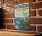 A vintage metal sign for the San Francisco Bay National Estuarine Research Reserve in California, featuring illustrations of the Golden Gate Bridge, a crane, and a bird.