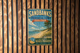 A vintage-style metal sign for Sandbanks Provincial Park, Ontario, Canada, featuring a beach scene and the text "Sandbanks Ontario Canada Beach Paradise Swim + Hike + Exploratory Relaxation".