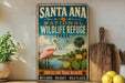 A vintage-style sign for Santa Ana National Wildlife Refuge in Texas, featuring an illustration of a pink egret and various wildlife elements.