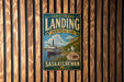 A vintage-style metal sign for Saskatchewan Landing, a scenic park in the heart of the Canadian prairie, is displayed on a wooden wall.