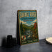 A vintage metal sign for Savage River State Forest in Maryland, featuring a scenic illustration of a river surrounded by trees and mountains.