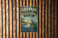 A vintage metal sign for the Savannah National Wildlife Refuge in Georgia, featuring a bird and a landscape scene.