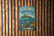 A vintage metal sign with a tropical island and sea turtle illustration, mounted on a wooden wall.