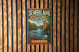 a vintage-style metal sign for Sembilang National Park, Indonesia, with a colorful illustration of a monkey and other wildlife in the background.