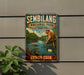 a vintage-style sign for the Sembilang National Park, which is a wildlife park in Indonesia. The sign depicts various animals, including a monkey, a bird, and a crocodile, along with a river and lush greenery. The sign is mounted on a wall, and there is a plant visible in the foreground.