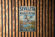 a vintage metal sign for the Seville National Wildlife Refuge in New Mexico, with a bird illustration and the text "SEVILLE" and "NATIONAL WILDLIFE REFUGE" prominently displayed.
