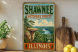 A vintage-style sign for Shawnee National Forest in Illinois, featuring a scenic landscape with a river and mountains.