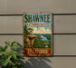 A vintage-style metal sign for Shawnee National Forest in Illinois, featuring a scenic landscape with a river and rock formations.