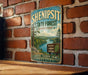 A vintage-style sign for Shenipit State Forest in Connecticut, featuring a scenic landscape with a river and pine trees.