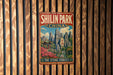 A vintage-style metal sign for Shilin Park, China, featuring a scenic landscape with mountains, pagodas, and a stone forest.