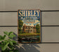 A vintage-style sign for Shirley Plantation, a historic plantation in Virginia, with a house and trees in the background.