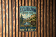 A vintage metal sign for Sica Hollow State Park in South Dakota, featuring a scenic mountain landscape.