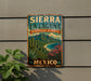 A vintage-style metal sign with the text "SIERRA LA LAGAÑA BIOSPHERE RESERVE MEXICO" and a scenic illustration of a tropical landscape with mountains, palm trees, and a beach.