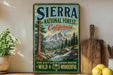 A vintage-style sign for Sierra National Forest, California, featuring a scenic mountain landscape with a river and pine trees.