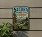 A vintage-style sign for Sierra National Forest, California, featuring a scenic mountain landscape with pine trees and a river.