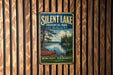 A vintage-style metal sign for Silent Lake Provincial Park in Ontario, featuring a scenic image of a lake with a canoe and pine trees.
