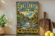 A vintage-style sign for Sinks Canyon State Park in Wyoming, featuring a scenic mountain landscape with a waterfall.