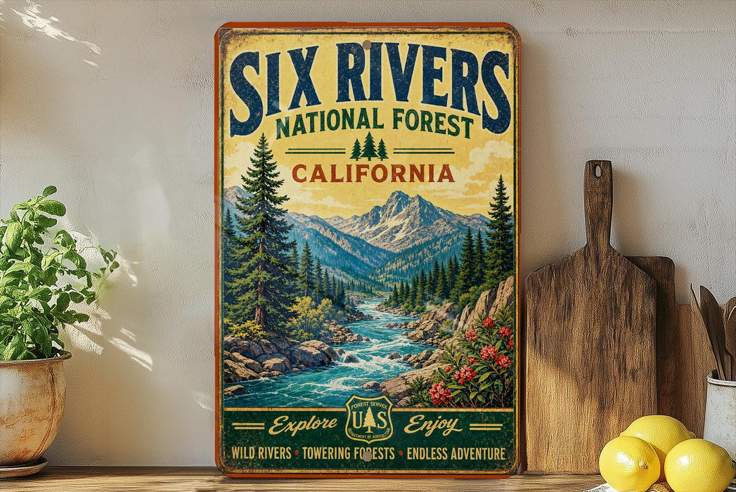 a vintage-style poster of the Six Rivers National Forest in California, with a scenic mountain landscape and a river flowing through it. The poster is displayed on a wall, and there are some potted plants and kitchen utensils, such as a knife and a spoon, visible in the foreground.
