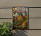 A vintage-style metal sign for the Smith Rock Summit Trail in Oregon, featuring a scenic mountain landscape with a winding trail.