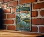A vintage metal sign for the South Slough National Estuarine Research Reserve in Oregon, featuring a blue heron and a river.