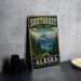 A vintage-style metal sign for Southeast State Forest Alaska, featuring a scenic mountain landscape with pine trees and a lake.