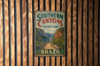 A vintage metal sign for Southern Canyons Pathways Park in Brazil, featuring a scenic illustration of a winding path through a mountainous landscape.