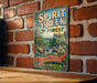 A vintage-style metal sign with the text "Spirit Creek Forest" and "Nature's Peace, Georgia's Beauty" hangs on a brick wall.
