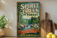 A vintage-style metal sign for Spirit Creek Forest in Georgia, featuring a scenic image of a forest and a waterfall.