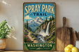 A vintage-style sign for the Spray Park Trail in Washington, featuring a scenic mountain landscape with a waterfall.