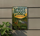 a vintage-style metal sign for Spruce Woods Provincial Park in Manitoba, Canada, with a scenic illustration of a deer in the foreground and a river in the background.