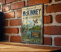 A vintage-style metal sign for the Stewart B. McKinney National Wildlife Refuge in Connecticut, featuring illustrations of birds and a river.