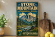 A vintage-style sign for Stone Mountain Provincial Park in British Columbia, Canada, featuring a scenic mountain landscape with pine trees and a river.