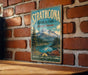 A vintage-style metal sign for Strathcona Provincial Park in British Columbia, Canada, featuring a scenic mountain landscape.