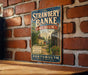 A vintage-style metal sign for the Strawberry Banke Museum, featuring a brick wall backdrop and a wooden table in the foreground.