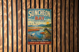 A vintage metal sign for Suncheon Bay, South Korea, featuring a scenic landscape with birds and a river.